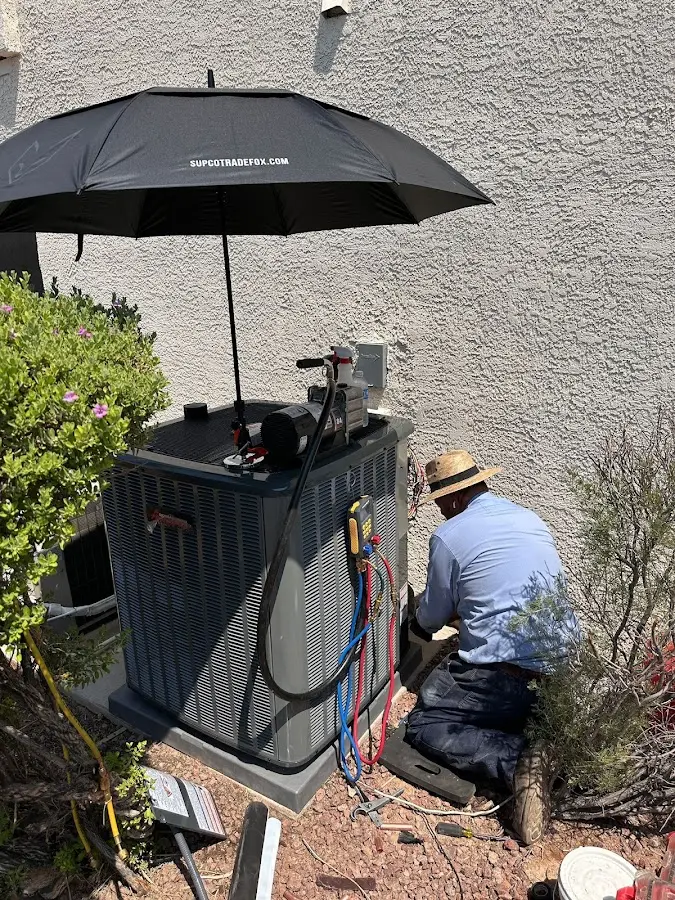 HVAC technician performing outdoor AC maintenance in Somers